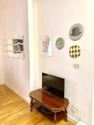 a living room with a tv and a table at la casa di Romolo in Rome