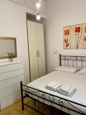 a bedroom with a bed with a dresser and a mirror at la casa di Romolo in Rome
