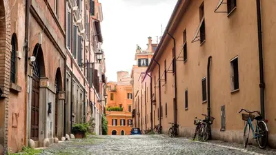 an alley with two bikes parked on a cobblestone street at la casa di Romolo in Rome