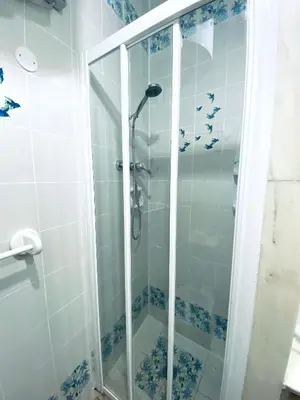 a shower with a glass door in a bathroom at la casa di Romolo in Rome