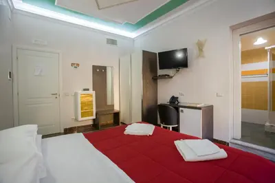 a bedroom with a red bed with two towels on it at Anthony 47 in Rome