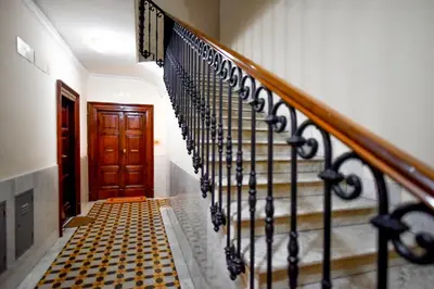 a stairway with a black and white tile floor and a wooden door at Anthony 47 in Rome