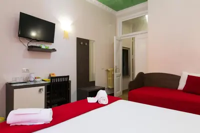 a bedroom with a bed and a couch and a tv at Anthony 47 in Rome