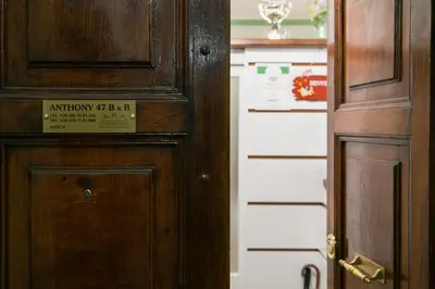 a wooden door with a sign on it next to another door at Anthony 47 in Rome