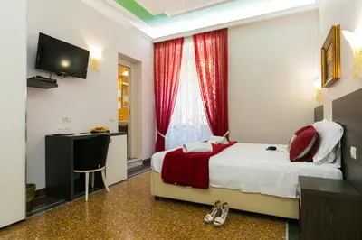 a bedroom with a bed and a desk and a television at Anthony 47 in Rome