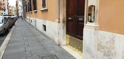 a sidewalk next to a building with cars parked at Anthony 47 in Rome