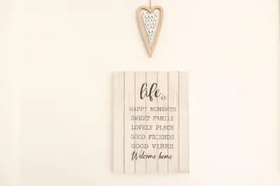 a silver heart pendant on a white background at White Fanti Apartment in Rome