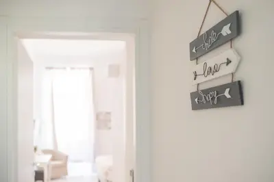 a sign on a door in a living room at White Fanti Apartment in Rome