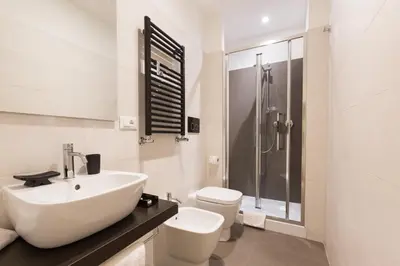 a bathroom with a sink and a toilet and a shower at Residenza Alexander Guest House in Rome