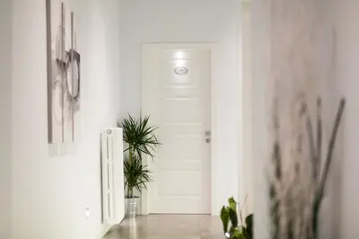 a hallway with a white door and a plant at Residenza Alexander Guest House in Rome
