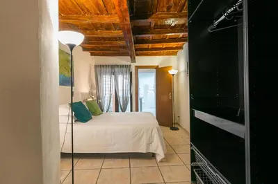 a bedroom with a bed in a room with wooden ceilings at Moro 50 - Loft in Trastevere in Rome