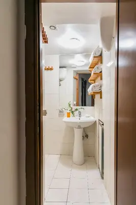 a bathroom with a sink and a toilet and a mirror at Moro 50 - Loft in Trastevere in Rome