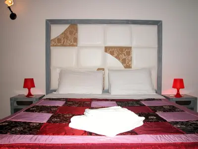 a bedroom with a large bed with two lamps at Gisa Apartment in Rome