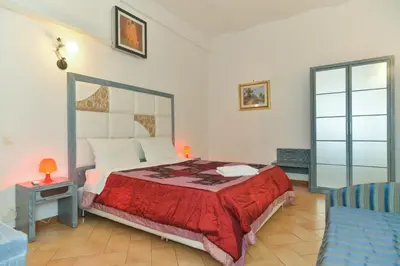 a bedroom with a bed with a red bedspread at Gisa Apartment in Rome