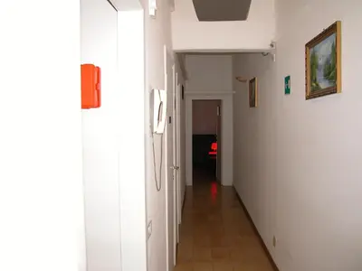 a hallway with white walls and a tile floor at Gisa Apartment in Rome