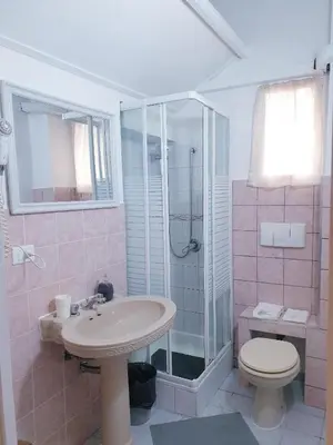 a bathroom with a sink and a shower and a toilet at Gisa Apartment in Rome