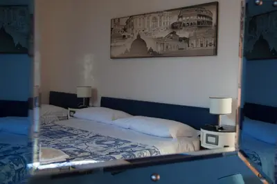 a reflection of a bedroom with a bed in a mirror at White Vatican in Rome