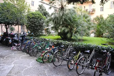 a row of bikes parked next to a wall at White Vatican in Rome