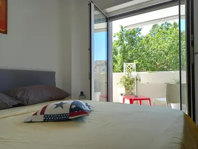 a bedroom with a bed and a large window at LIVING ROME Int 2 in Rome