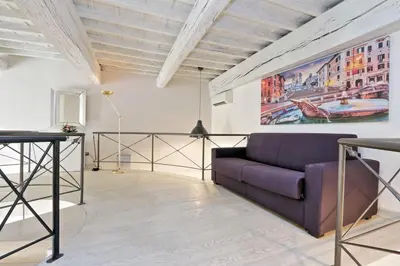a living room with a purple couch and a painting at Restart Accommodations Borghese in Rome
