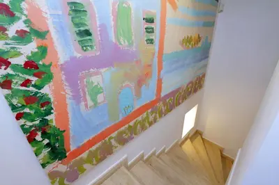 a painting on the wall of a stairway at Restart Accommodations Borghese in Rome