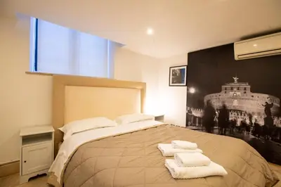 a bedroom with a large bed with towels on it at Restart Accommodations Borghese in Rome