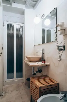 a bathroom with a wooden sink and a mirror at Restart Accommodations Borghese in Rome