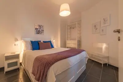 a bedroom with a large bed with blue pillows at Romantic Apartment in Rome, 50 sqm, Parking in Rome