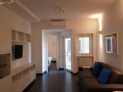 a living room with a couch and a television at Romantic Apartment in Rome, 50 sqm, Parking in Rome