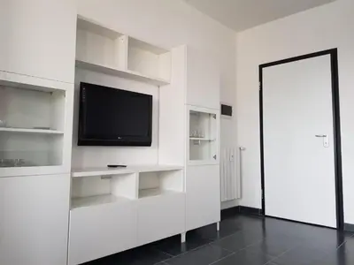 a white room with a television and white shelves at Romantic Apartment in Rome, 50 sqm, Parking in Rome