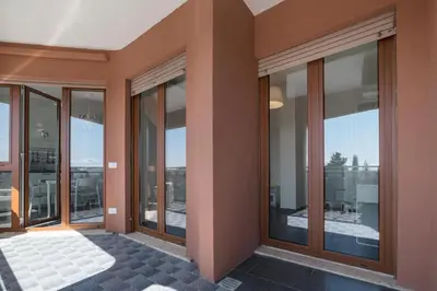 a room with large glass windows in a building at Charming Apartment in Rome + Internet in Rome