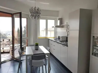 a kitchen with a table and a white refrigerator at Charming Apartment in Rome + Internet in Rome