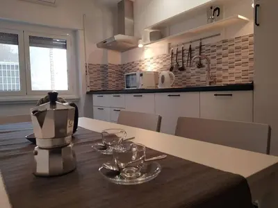 a kitchen with a table with wine glasses on it at Charming Apartment in Rome + Internet in Rome
