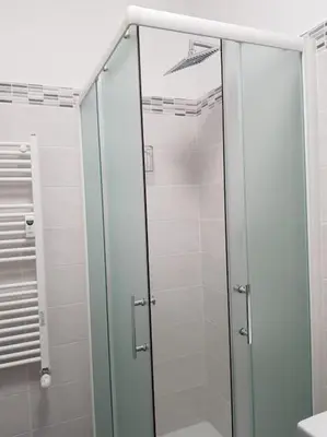 a shower with a glass door in a bathroom at Charming Apartment in Rome + Internet in Rome