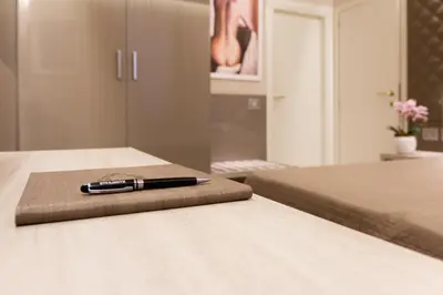 a pen sitting on top of a bed at Harry's Bar Trevi Luxury Apartments - Spagna in Rome