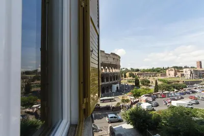 a bedroom with a white bed with a black and white pillow at B&B Colosseo Panoramic Rooms in Rome