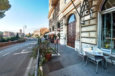 a table and chairs on a sidewalk next to a building at B&B Colosseo Panoramic Rooms in Rome