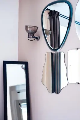 a mirror hanging on a wall next to a sink at Restart Accommodations Aldobrandini e Sciarra in Rome