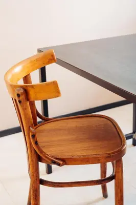 a wooden chair sitting in front of a table at Restart Accommodations Aldobrandini e Sciarra in Rome