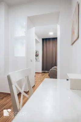 a white room with a table and a chair at Restart Accommodations Aldobrandini e Sciarra in Rome