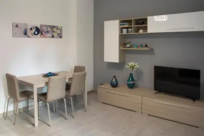 a living room with a dining room table and a television at Mimma's House Private Garden near Trastevere in Rome