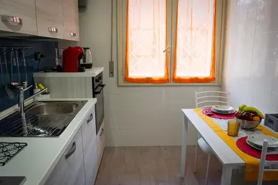 a small kitchen with a sink and a table at Mimma's House Private Garden near Trastevere in Rome
