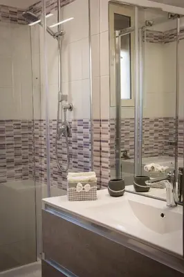 a bathroom with a sink and a shower at Mimma's House Private Garden near Trastevere in Rome