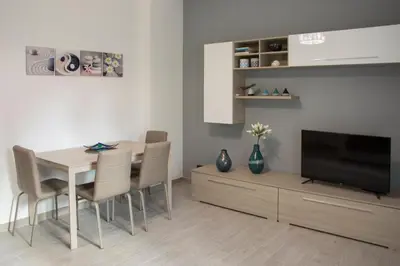 a living room with a dining room table and a television at Mimma's House Private Garden near Trastevere in Rome