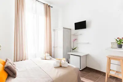 a hotel room with a bed and a television at Domus Victoria Guest House in Rome