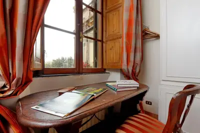 a wooden table in a room with a window at TreasureRome Daphne Terrace in Rome