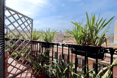 a balcony with plants on top of a building at TreasureRome Daphne Terrace in Rome