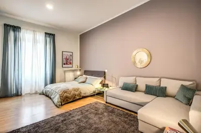 a living room with a couch and a bed at Diocleziano Triple in Rome