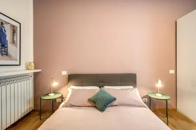a bedroom with a bed with two side tables at Diocleziano Triple in Rome