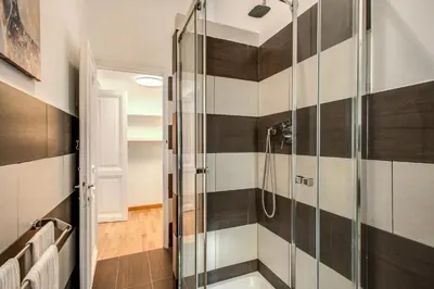 a bathroom with a shower with black and white stripes at Diocleziano Triple in Rome
